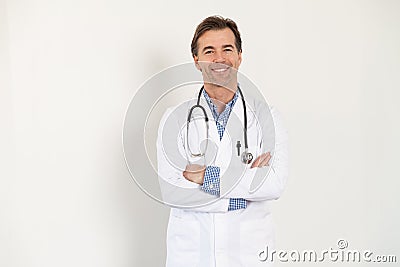 Middle aged handsome doctor crossed arms on white Stock Photo