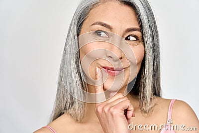Happy middle aged mature asian woman portrait looking flirty away. Stock Photo