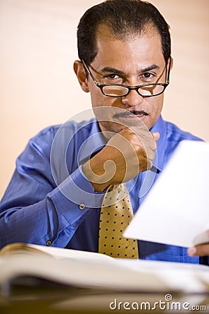 Middle-aged Hispanic businessman working in office Stock Photo