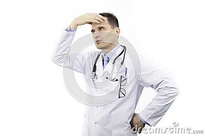 Middle-aged male doctor looks tired and tortured with hand on forehead Stock Photo