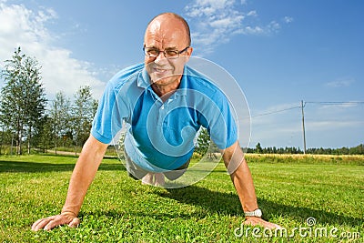 Middle-aged man doing push-ups Stock Photo