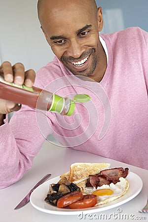 Middle Aged Man Eating Unhealthy Fried Breakfast Stock Photo