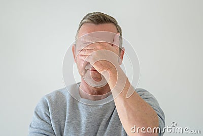 Middle-aged man with facepalm gesture Stock Photo
