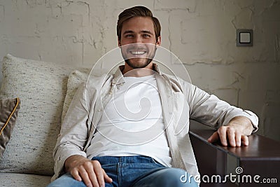 Middle-aged man having a restful moment relaxing in sofa. Stock Photo