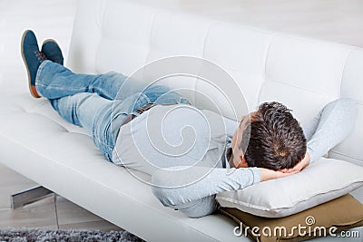 Middle-aged man having restful moment relaxing in sofa Stock Photo