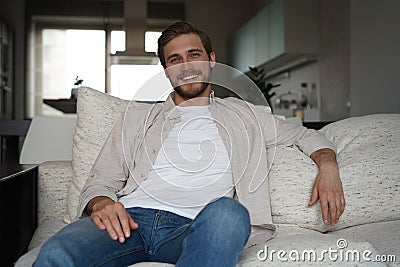 Middle-aged man having a restful moment relaxing in sofa. Stock Photo