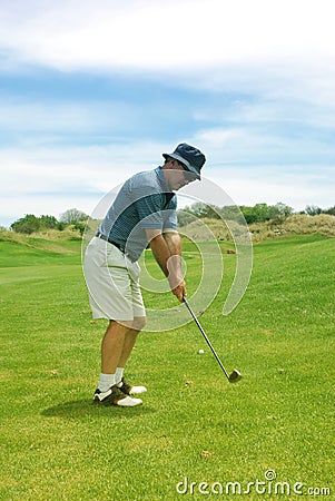 Middle aged man playing golf. Stock Photo