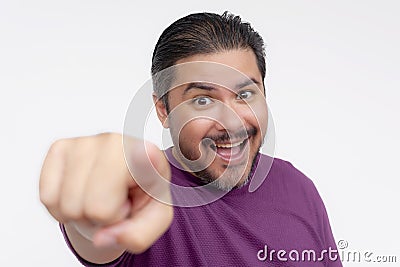 A middle aged man points forward with his finger while looking hyped, energized or maniacal. Choosing you. Headshot photo isolated Stock Photo