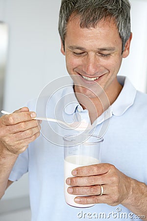 Middle Aged Man Preparing A Dietary Supplement Stock Photo