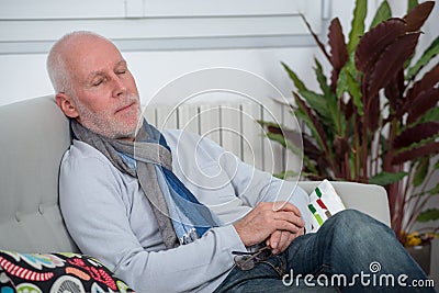 Middle-aged man relaxing a moment in sofa Stock Photo