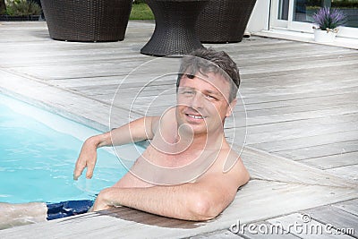 Middle aged man sit in pool relax in vaction day Stock Photo