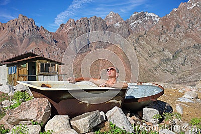 Middle-aged man taking a bath outdoors Stock Photo
