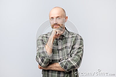 Middle aged man thinking, expressing leadership reflections and concerns, trying to make a decision. Stock Photo