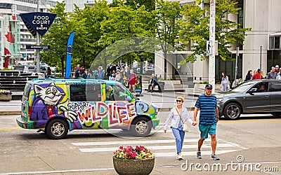 Middle-aged man walking with his wife at the urban street of a city. Portrait of happy middle aged couple Editorial Stock Photo