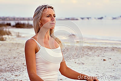 Middle aged 50s yogi woman meditating on nature Stock Photo