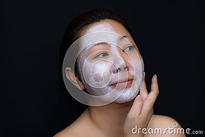 A middle-aged woman Asians are happy with a face mask for skin c Stock Photo