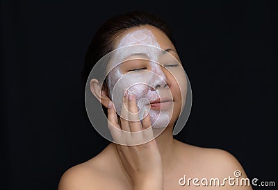 A middle-aged woman Asians are happy with a face mask for skin c Stock Photo