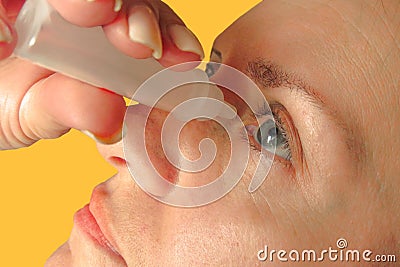 Middle aged woman drops eyes. Macro closeup image of face. Medical procedure at home. Girl holding eyedropper bottle and dropping Stock Photo