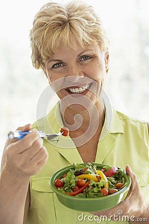 Middle Aged Woman Eating Fresh Salad Stock Photo