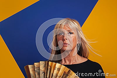 Middle-Aged Woman Having A Hot flash, Holding a Fan Stock Photo