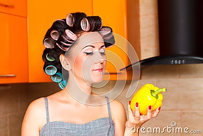 Middle-aged woman housewife in the kitchen with sweet pepper Stock Photo