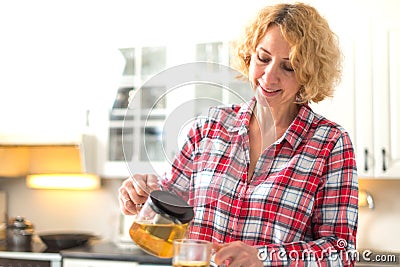 Middle aged woman pouring tea Stock Photo