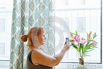 woman photographing bouquet flowers with smartphone Stock Photo