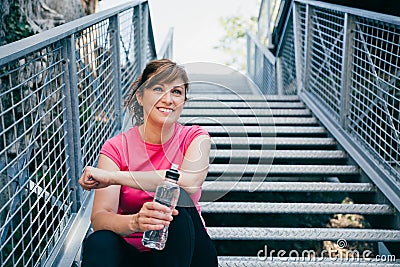 Middle aged woman relaxing after training Stock Photo