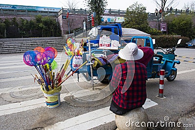 A middle-aged woman selling small commodities Editorial Stock Photo