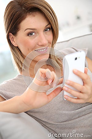 Middle-aged woman sending message Stock Photo