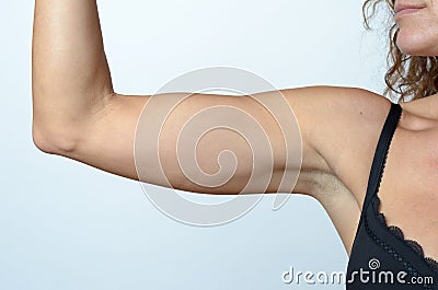 Middle aged woman showing flabby arm Stock Photo