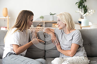 Two female sitting on couch and talking Stock Photo