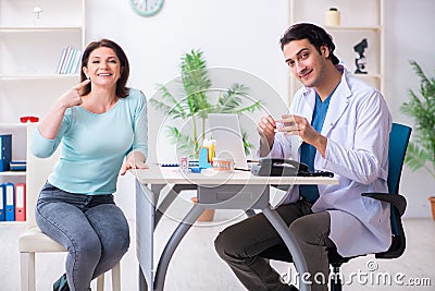 Middle-aged woman visiting male doctor stomatologist Stock Photo