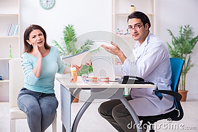 Middle-aged woman visiting male doctor stomatologist Stock Photo