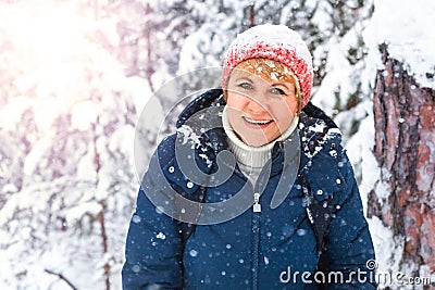 A woman walks in a winter Park among the pines Stock Photo