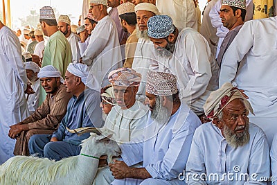 Men with a goat at the animal souk in Nizwa Editorial Stock Photo