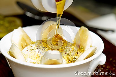 Middle eastern creamy dessert with nuts and honey Stock Photo