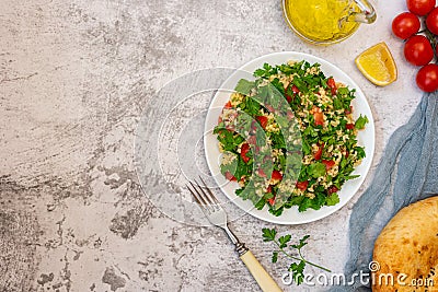 Middle Eastern cuisine. Vegetarian salad with bulgur, vegetables. Fresh bright arabic salad. Tabbouleh salad Stock Photo