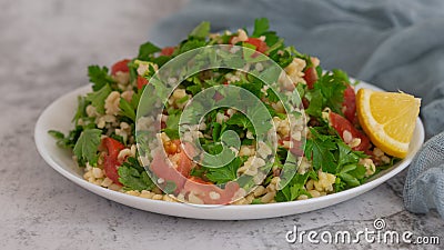 Middle Eastern cuisine. Vegetarian salad with bulgur, vegetables. Fresh bright arabic salad. Tabbouleh salad Stock Photo