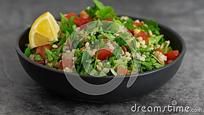 Middle Eastern cuisine. Vegetarian salad with bulgur, vegetables. Fresh bright arabic salad. Tabbouleh salad Stock Photo