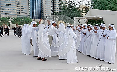 Middle Eastern Culture - Emirati Men performing Al Ayala traditional dance - Arabic men in traditional cloth Editorial Stock Photo