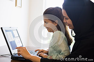 A Middle Eastern woman and daughter at home Stock Photo