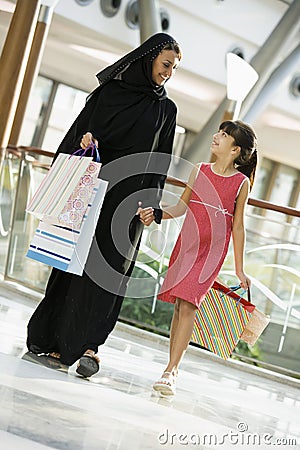 A Middle Eastern woman with a girl shopping Stock Photo