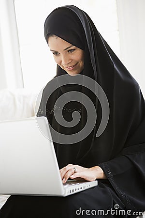 A middle eastern woman using a laptop Stock Photo