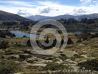 In the middle of high mountains, viewsight of three lakes in the reserve of high pyrenees neouvielle France, Stock Photo