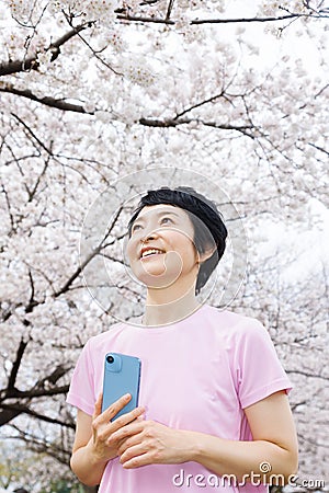 Middleage woman shooting with a smartphone Stock Photo