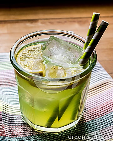 Midori Sour Cocktail with ice and lemon. Stock Photo