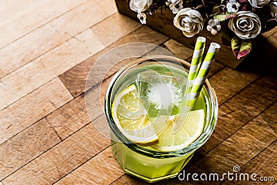 Midori Sour Cocktail with ice and lemon. Stock Photo