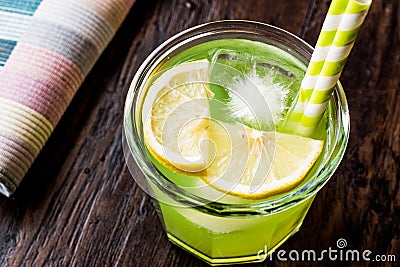 Midori Sour Cocktail with ice and lemon. Stock Photo