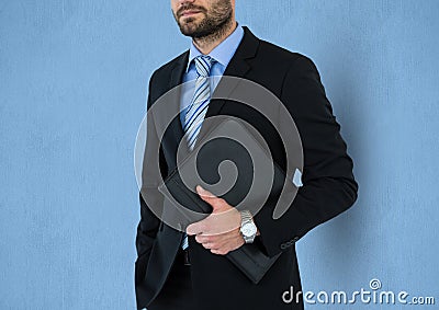 Midsection of businessman holding folder against blue background Stock Photo